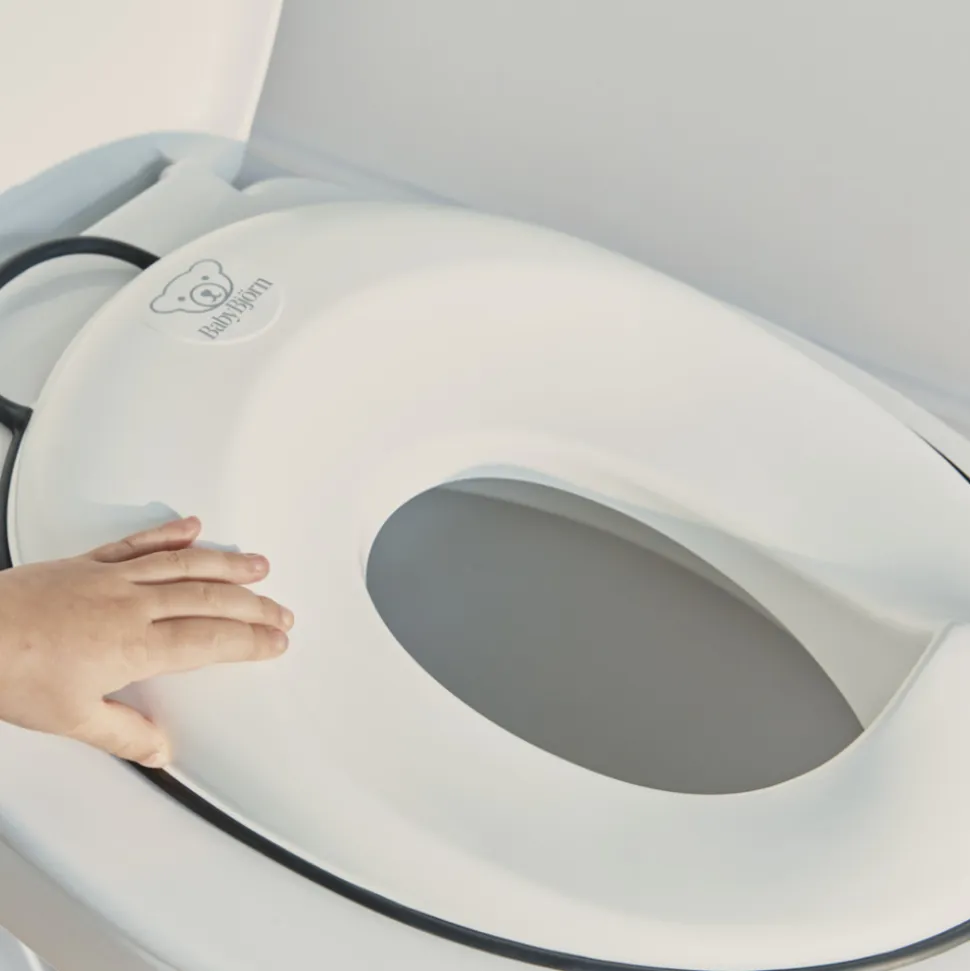 Réducteur de toilette blanc et noir